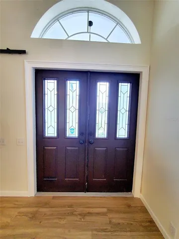 a view of entryway with window and wooden floor