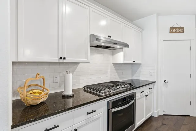 a kitchen with stainless steel appliances a refrigerator stove and microwave