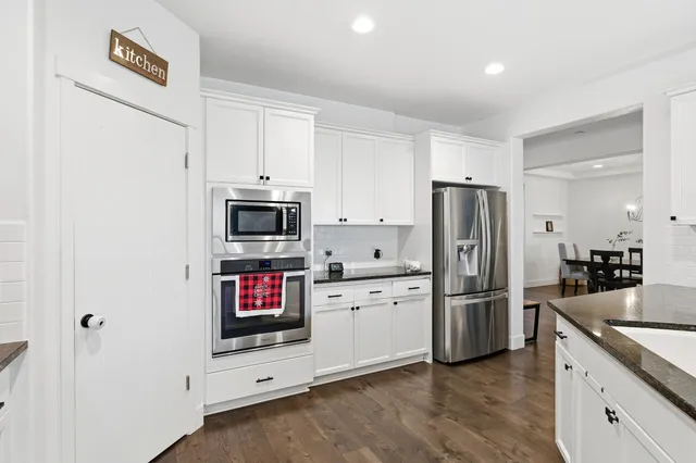 a kitchen with stainless steel appliances granite countertop a sink a stove and a granite counter tops