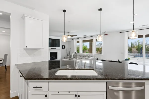 a kitchen with stainless steel appliances granite countertop a sink refrigerator and cabinets