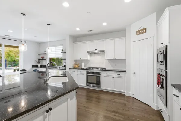 a hallway with a couch and a wooden floor