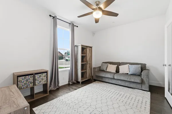 a living room with furniture and a wooden floor