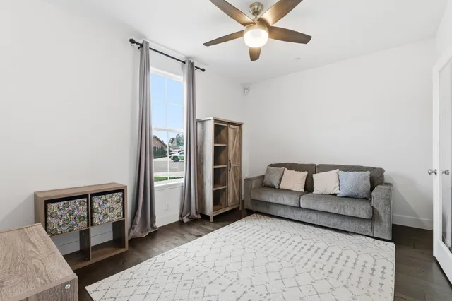 a living room with furniture and a wooden floor