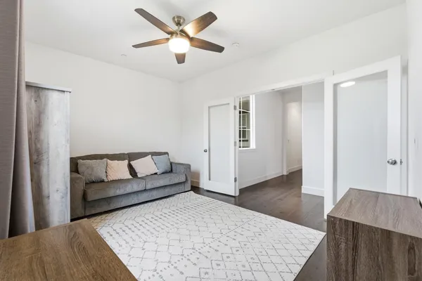 a spacious bathroom with a granite countertop sink a mirror a bathtub and shower