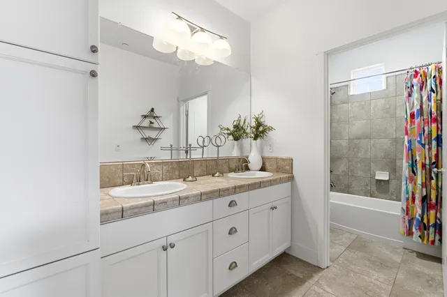 a bathroom with a bathtub and a shower curtain