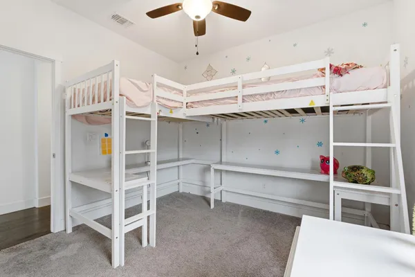 a bedroom with a bed and ceiling fan
