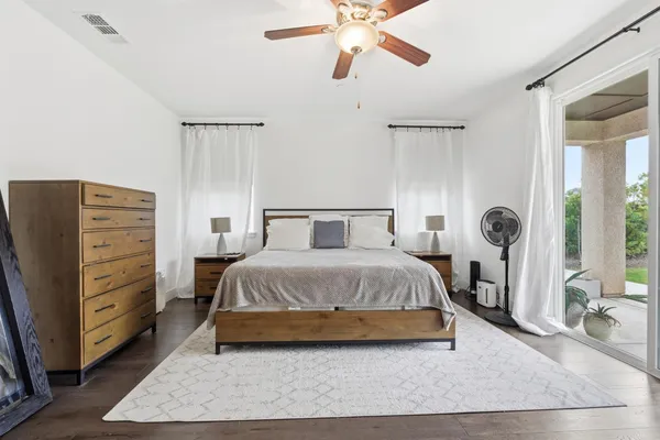 a bathroom with a granite countertop sink a mirror and a shower