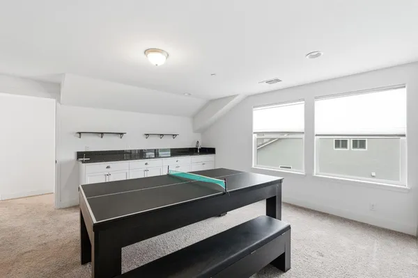 a living room with furniture and kitchen view