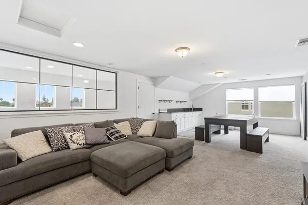 an empty room with a window and dresser