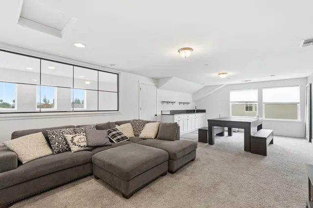 an empty room with a window and dresser