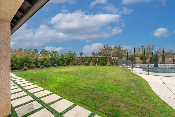 a swimming pool with outdoor seating yard and barbeque oven
