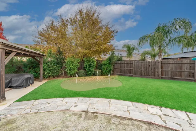 a view of a patio with table and chairs potted plants with wooden fence