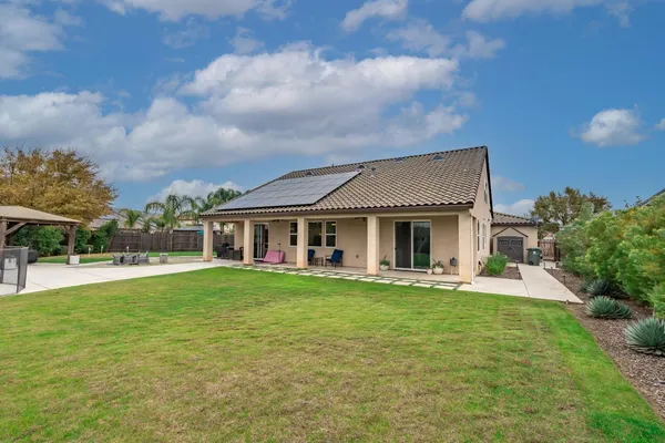 a front view of a house with a garden and yard