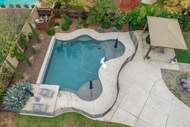 an aerial view of residential house with outdoor space and parking