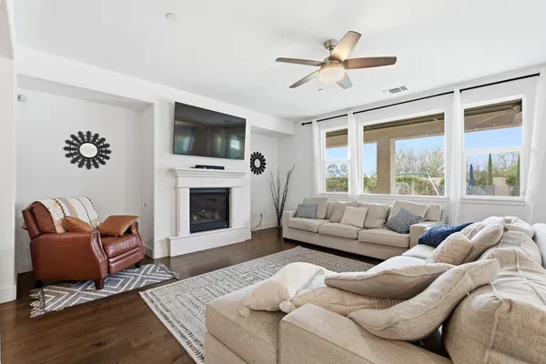 a living room with furniture a flat screen tv and a fireplace