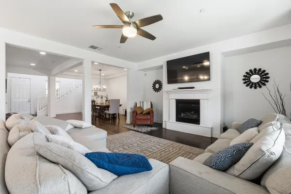 a living room with furniture a flat screen tv and a fireplace