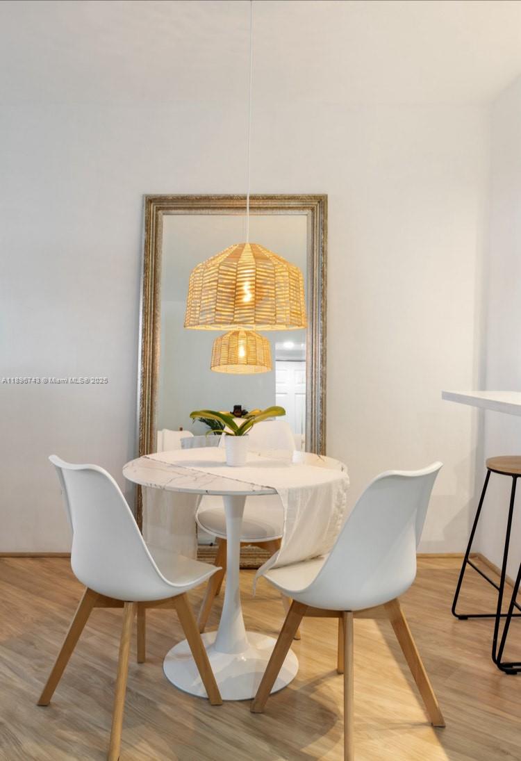 2899 Collins Avenue, Unit 1638 Miami Beach, FL 33140 - Photo 8 of 14 a view of a dining room with a table and chairs