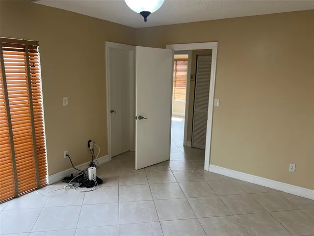a view of a room with furniture and a window