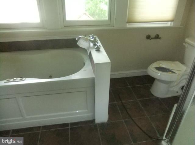 4210 Clarkdale Road Baltimore, MD 21209 - Photo 2 of 9 a bathroom with a toilet and a sink