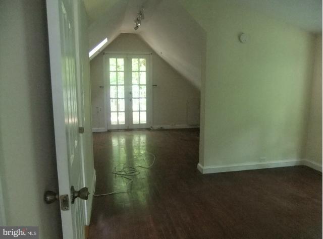 4210 Clarkdale Road Baltimore, MD 21209 - Photo 8 of 9 an empty room with wooden floor and windows