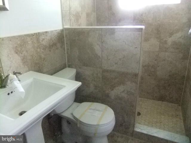 4210 Clarkdale Road Baltimore, MD 21209 - Photo 9 of 9 a bathroom with a sink and a toilet