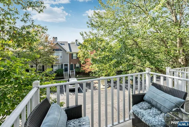 a balcony with wooden floor and outdoor space