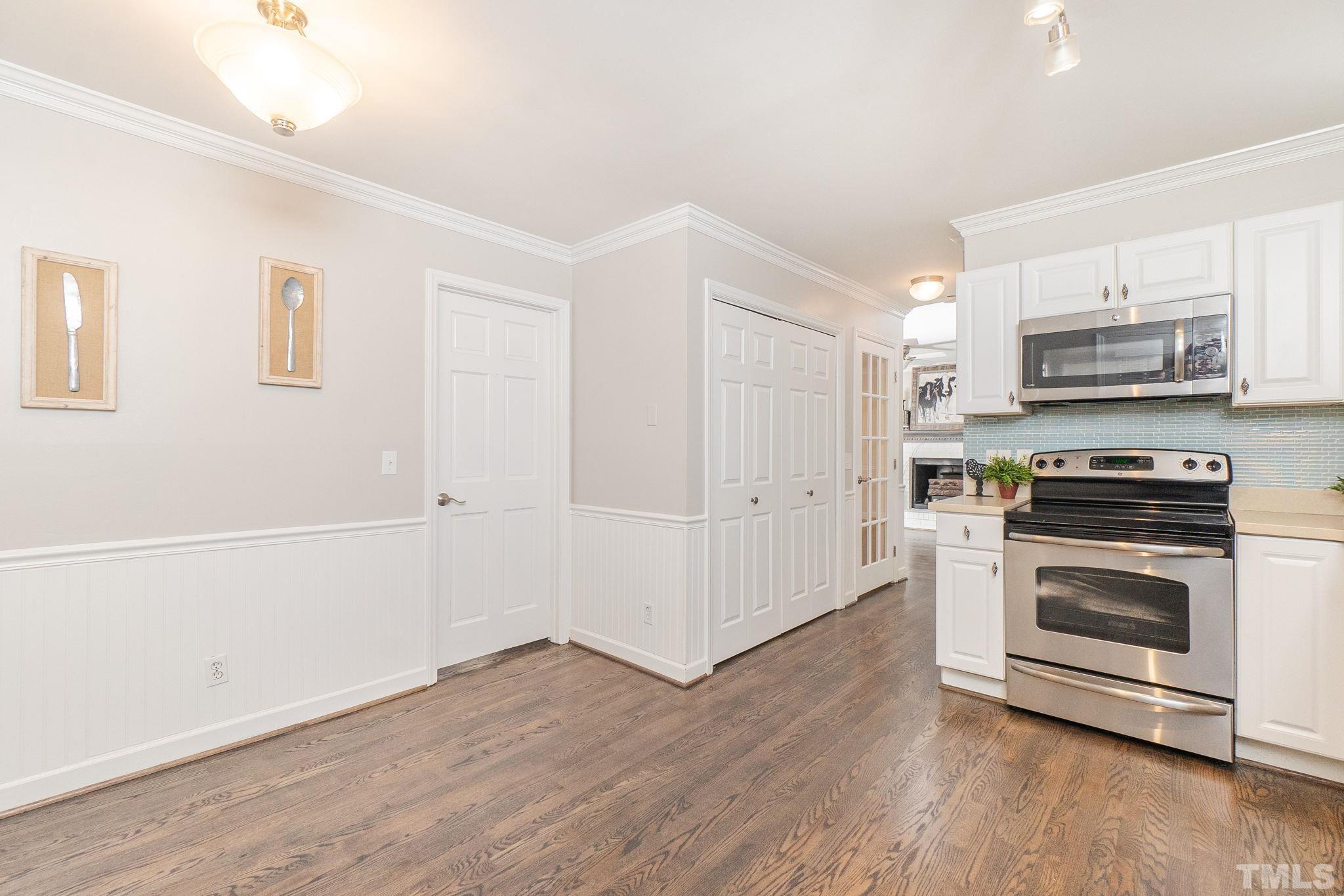 7544 Milestone Court Raleigh, NC 27615 - Photo 11 of 30 a kitchen with wooden cabinets and stainless steel appliances