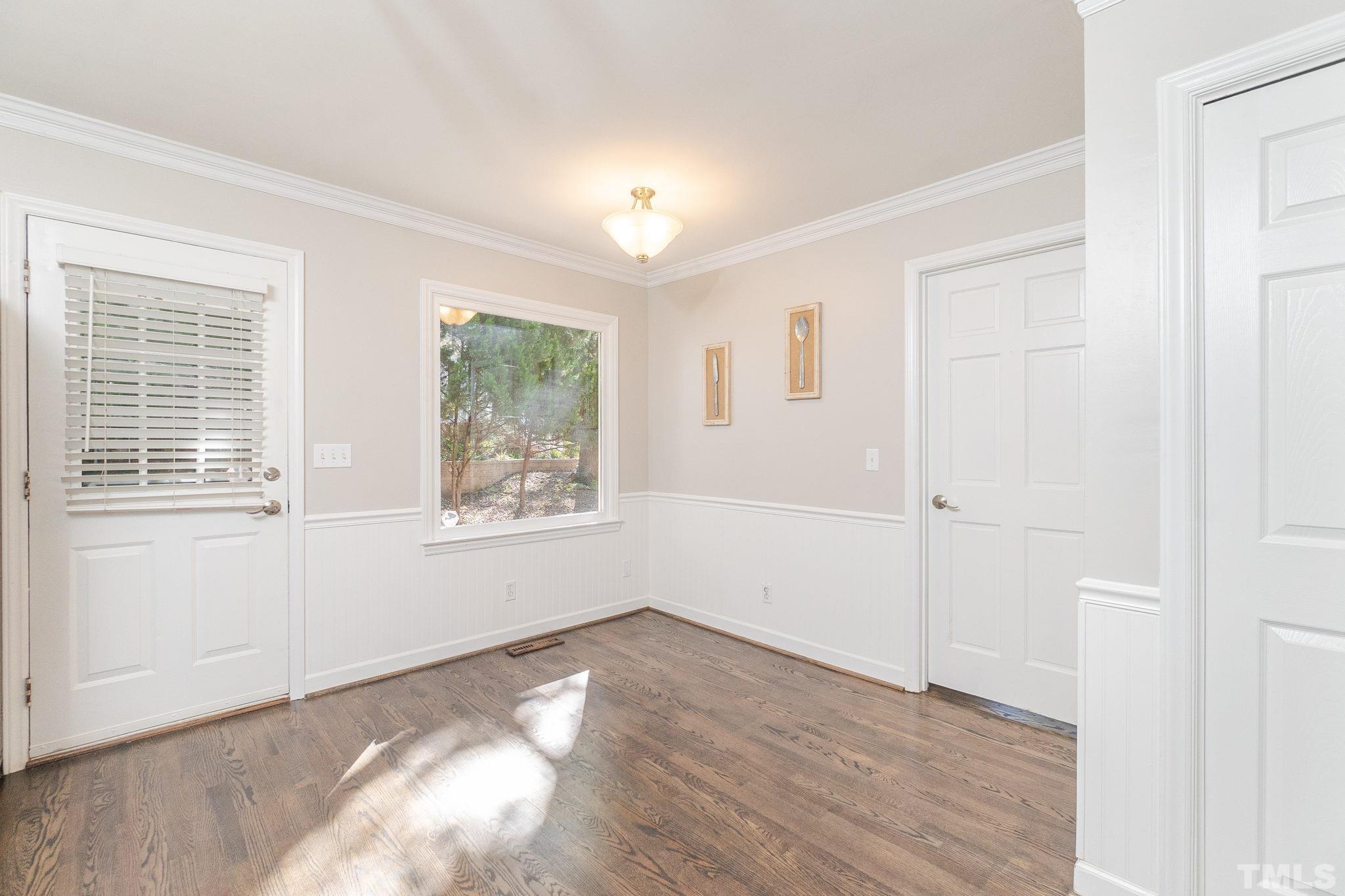 7544 Milestone Court Raleigh, NC 27615 - Photo 12 of 30 a view of an empty room with wooden floor and a window