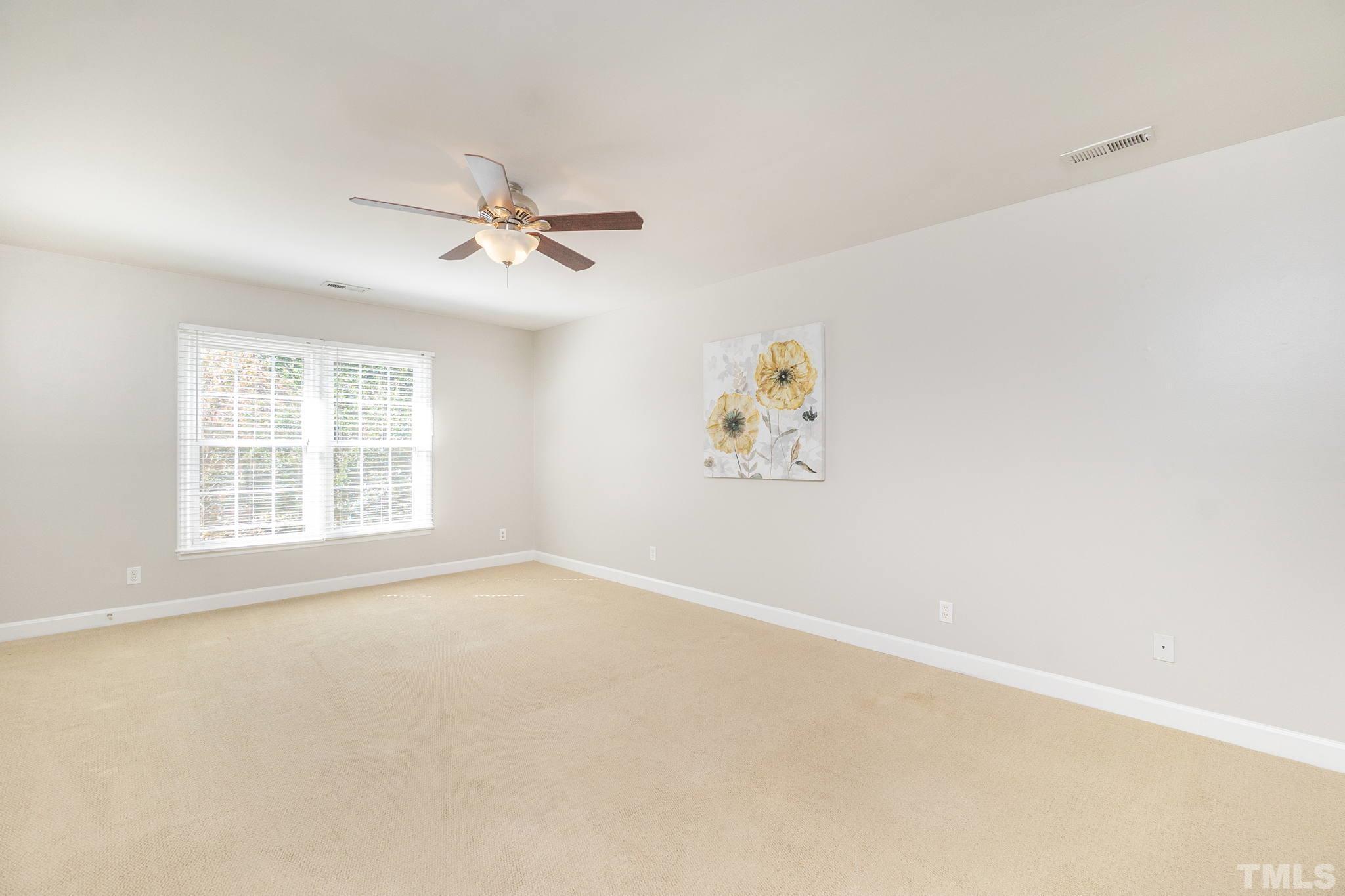 7544 Milestone Court Raleigh, NC 27615 - Photo 18 of 30 an empty room with windows and fan