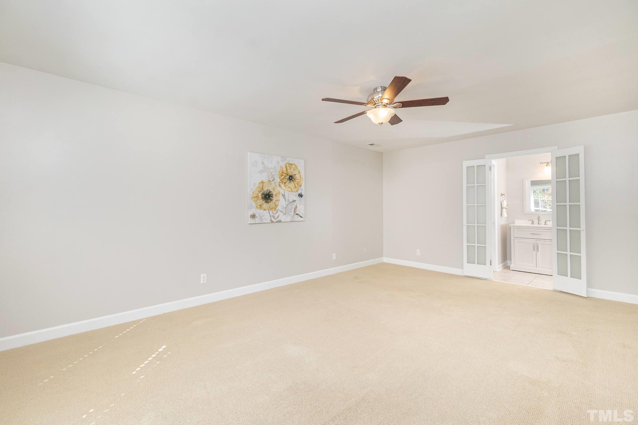 7544 Milestone Court Raleigh, NC 27615 - Photo 19 of 30 an empty room with windows and ceiling fan