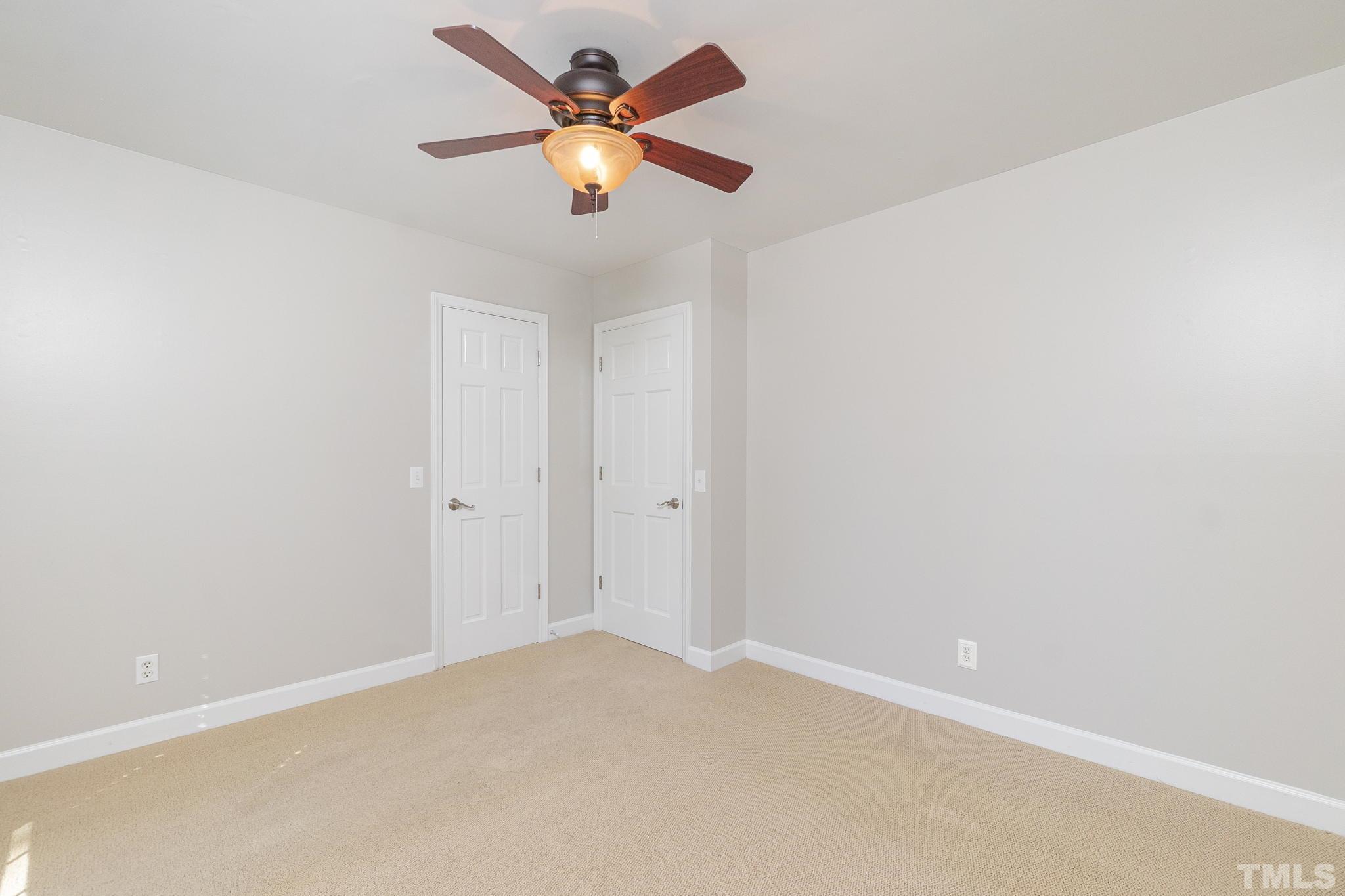 7544 Milestone Court Raleigh, NC 27615 - Photo 23 of 30 an empty room with a chandelier fan and a window