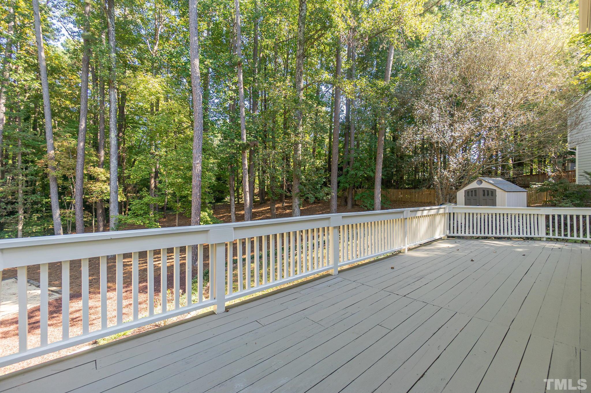 7544 Milestone Court Raleigh, NC 27615 - Photo 26 of 30 a view of a wooden deck and trees in the roof