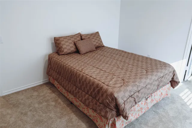 a large bed sitting in a bedroom next to a wall