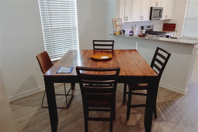 a dining room with furniture and window