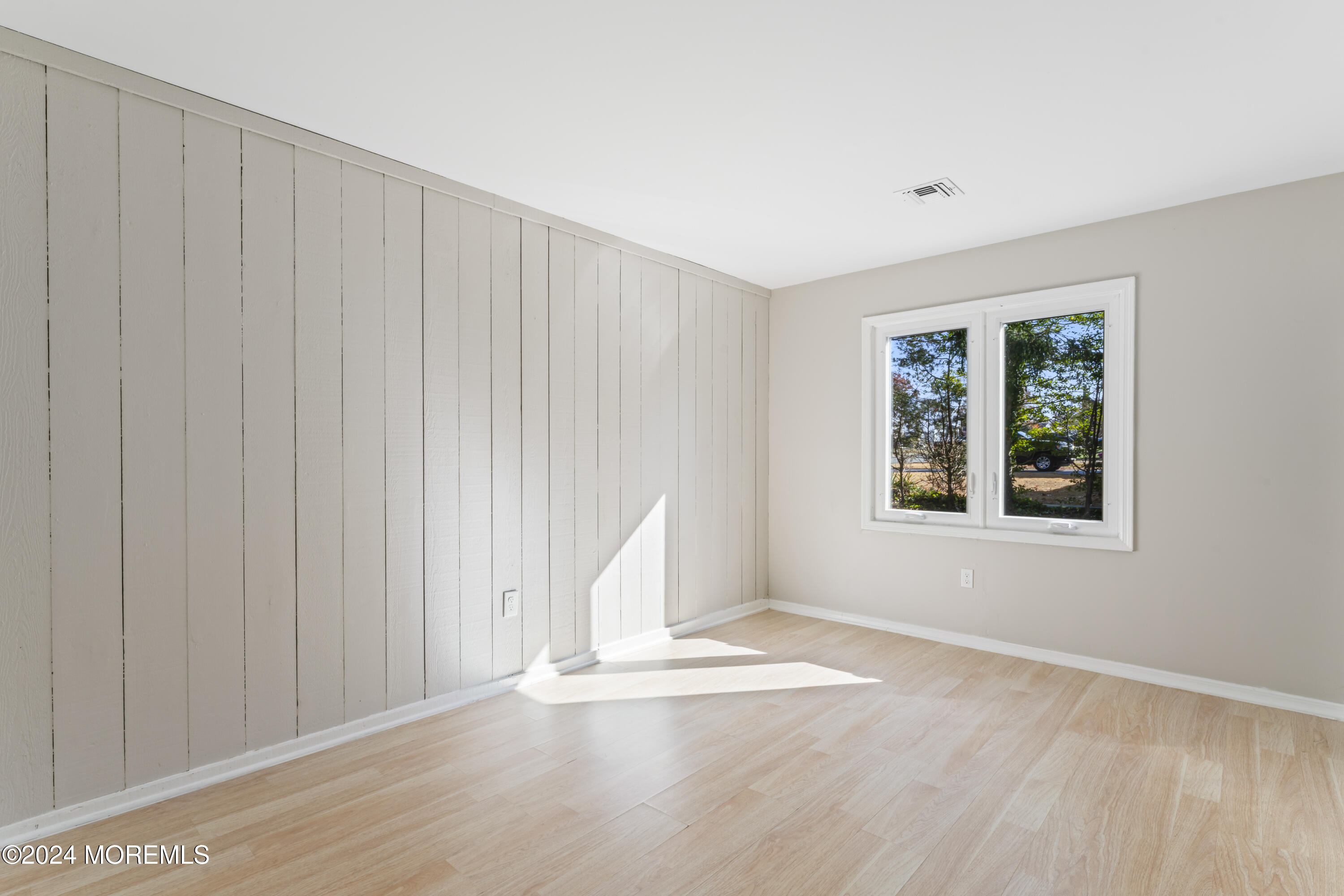 321 Float Avenue Manahawkin, NJ 08050 - Photo 10 of 31 an empty room with wooden floor and windows