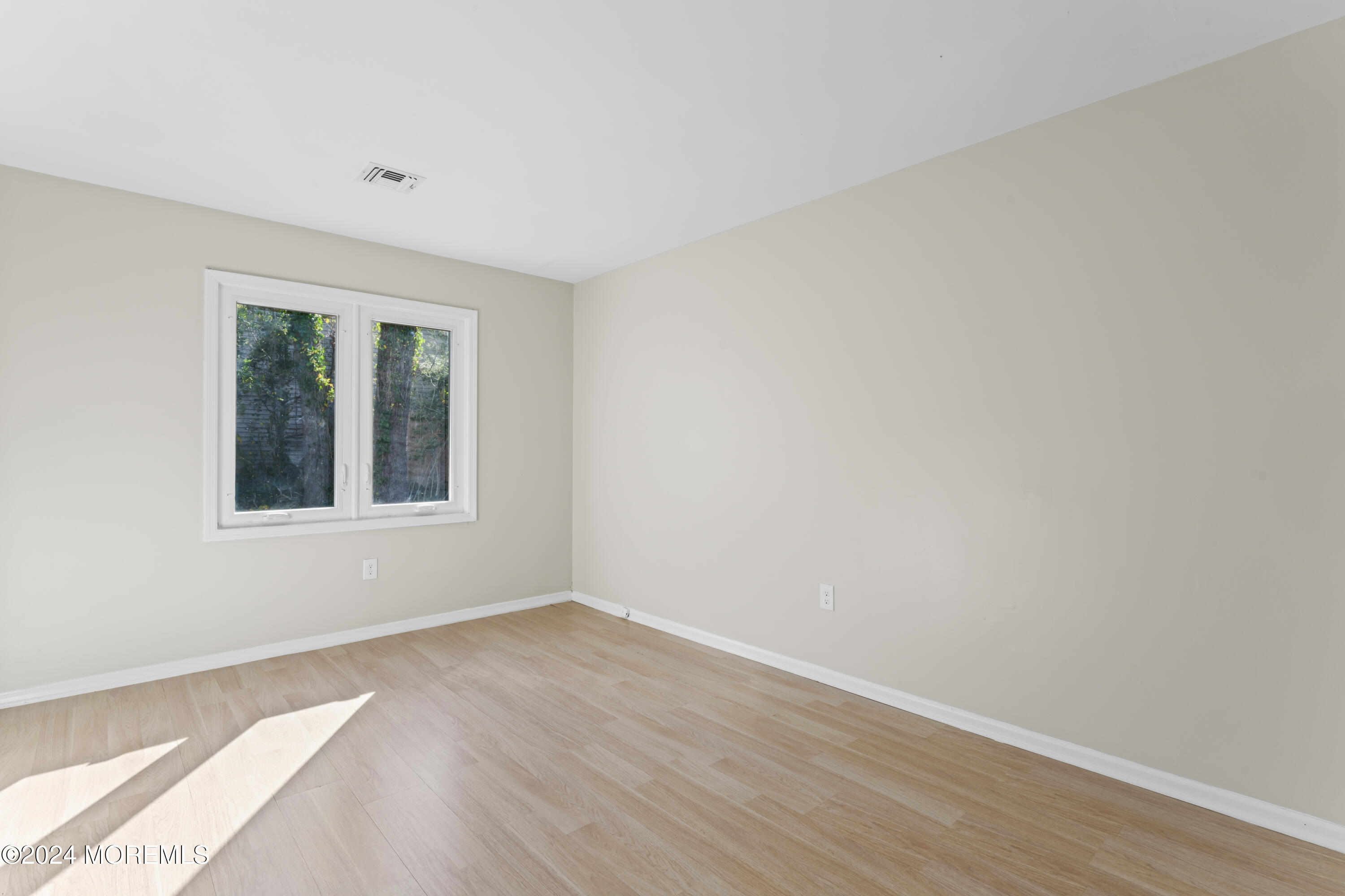 321 Float Avenue Manahawkin, NJ 08050 - Photo 12 of 31 a view of an empty room with wooden floor and a window