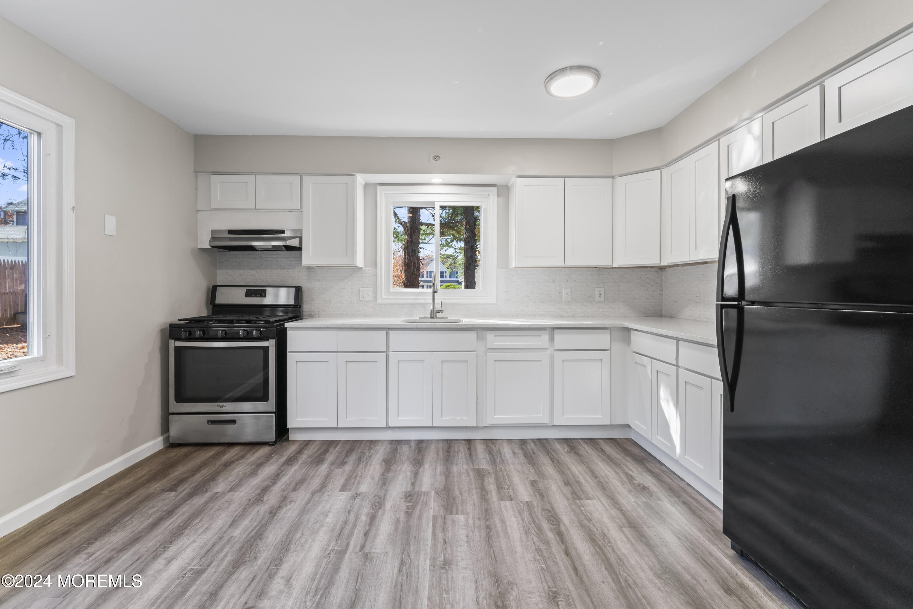 321 Float Avenue Manahawkin, NJ 08050 - Photo 14 of 31 a kitchen with a refrigerator and a stove top oven