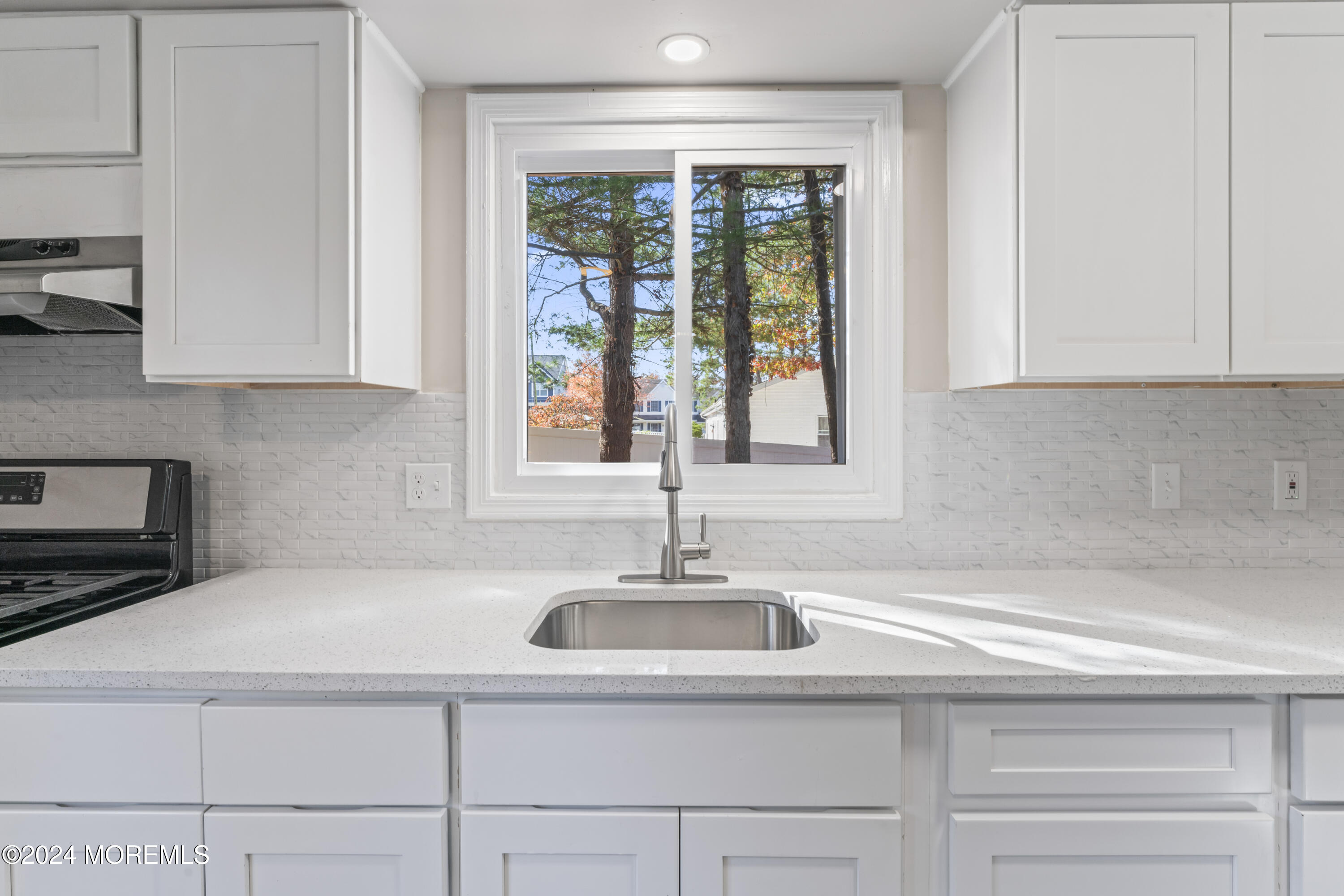 321 Float Avenue Manahawkin, NJ 08050 - Photo 15 of 31 a kitchen with a sink and cabinets