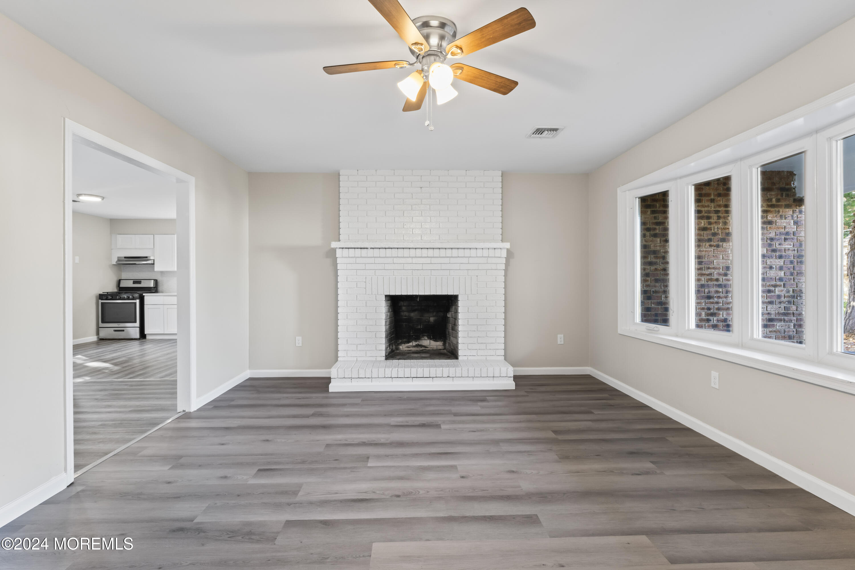 321 Float Avenue Manahawkin, NJ 08050 - Photo 17 of 31 a view of an empty room with a window and a kitchen
