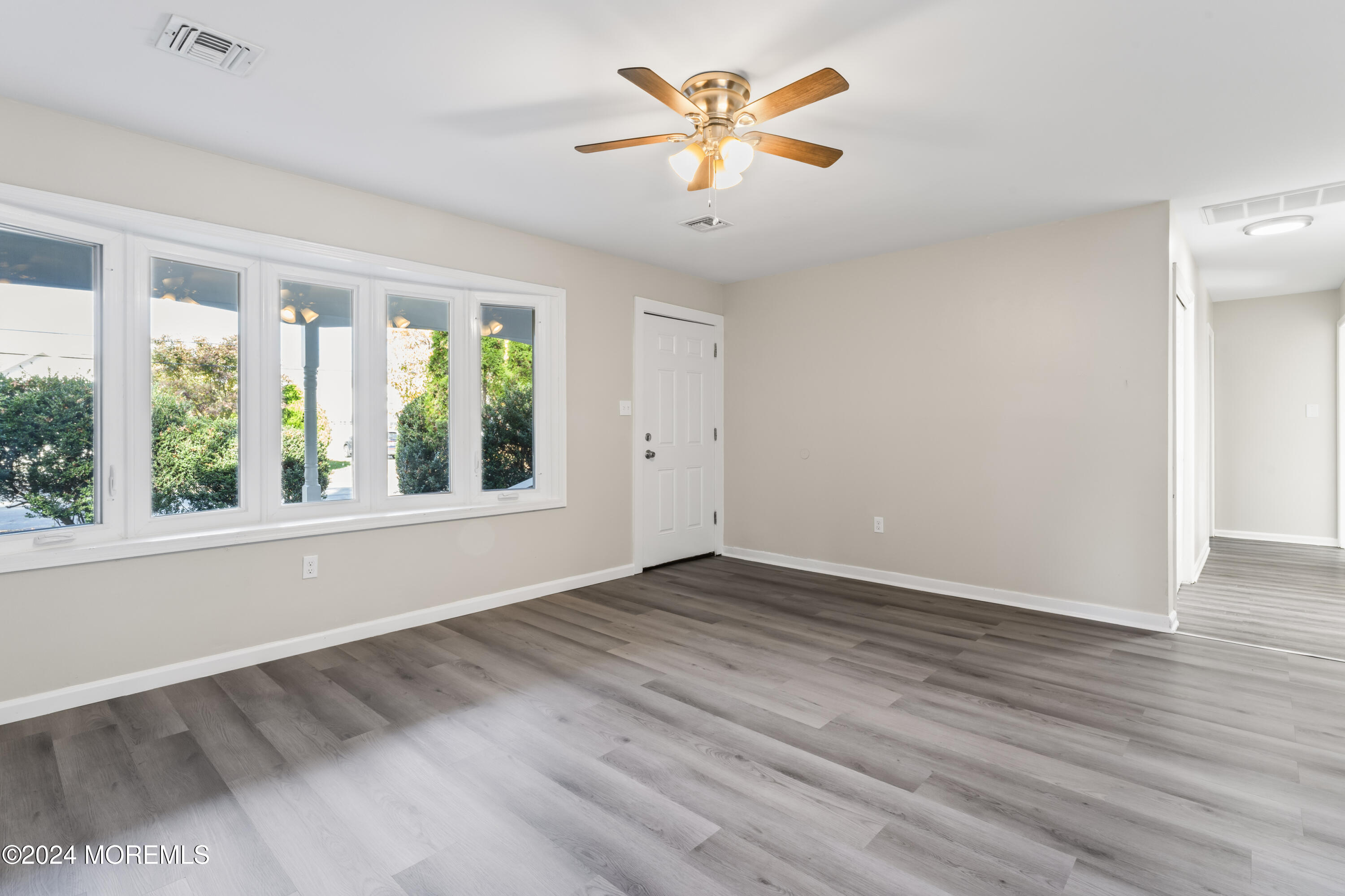 321 Float Avenue Manahawkin, NJ 08050 - Photo 18 of 31 wooden floor in an empty room with a window