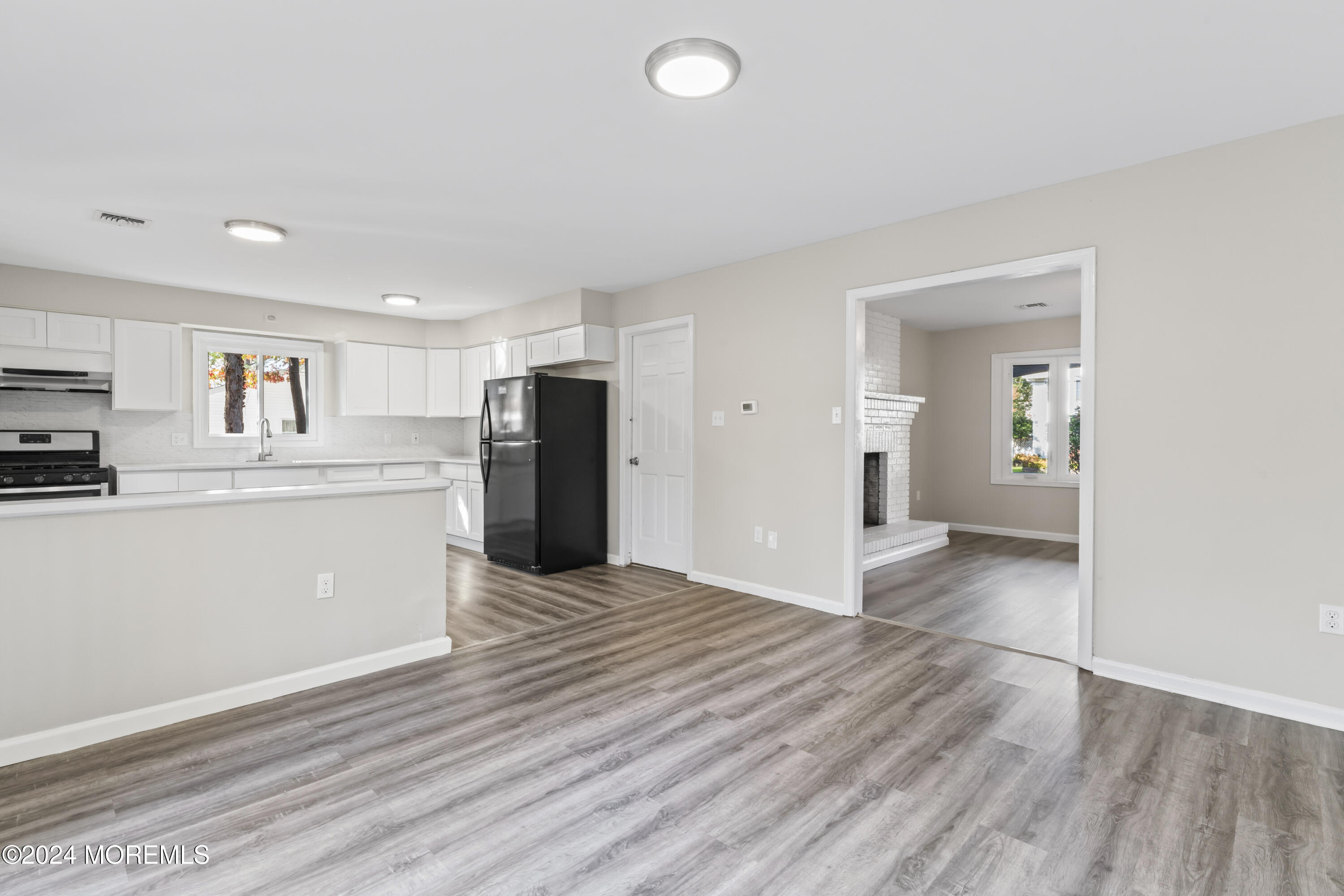 321 Float Avenue Manahawkin, NJ 08050 - Photo 20 of 31 a kitchen with stainless steel appliances kitchen island granite countertop a refrigerator and a sink
