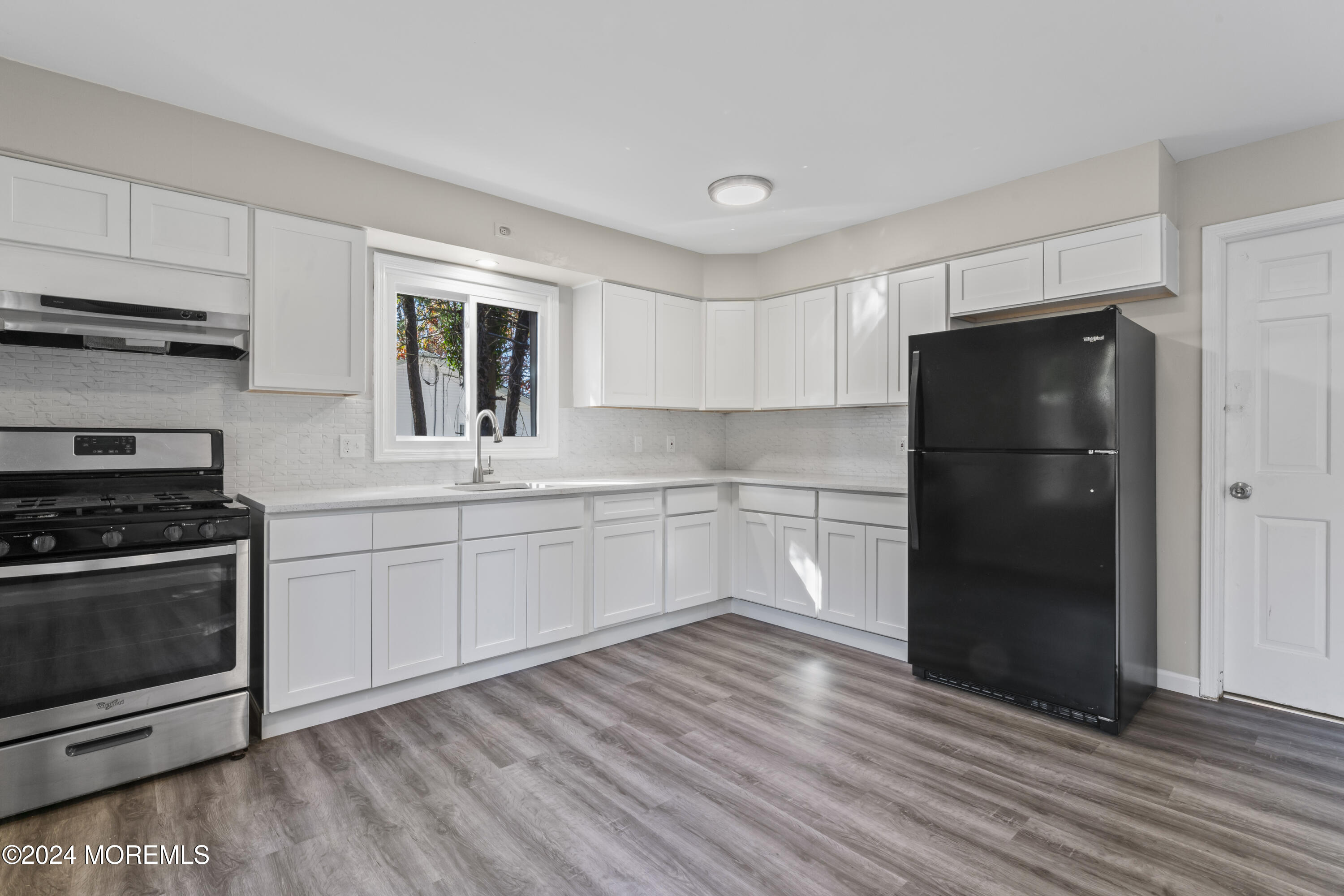 321 Float Avenue Manahawkin, NJ 08050 - Photo 4 of 31 a kitchen with a refrigerator stove and white cabinets