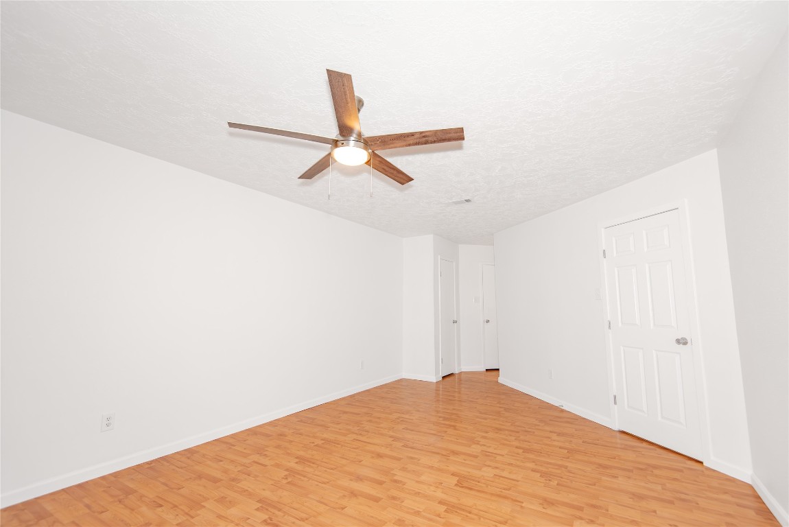 21734 Nickerton Lane Spring, TX 77388 - Photo 14 of 31 Primary bedroom with a clear view toward the en-suite and adjoining closets.
