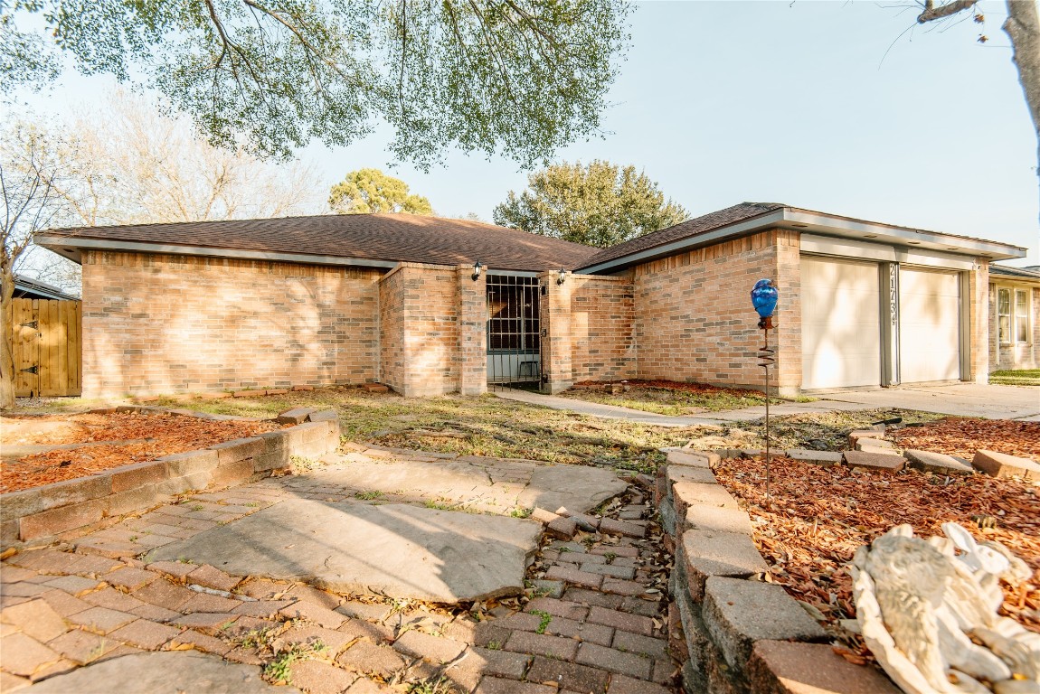 21734 Nickerton Lane Spring, TX 77388 - Photo 2 of 31 Inviting front entry framed by established trees and simple, tidy landscaping.
