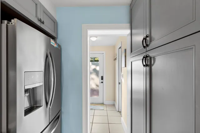 a view of a refrigerator in kitchen and an entryway