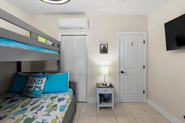 a bedroom with a bed and a television