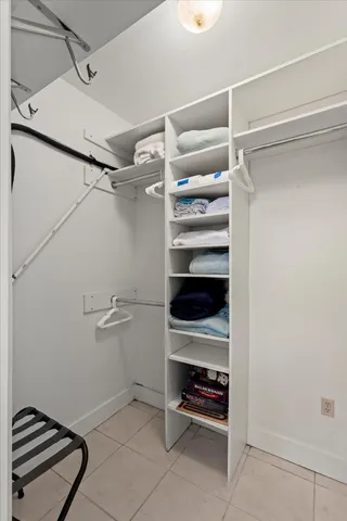 a view of walk in closet with empty racks
