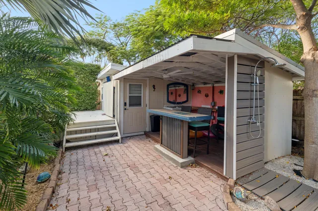 a view of backyard with plants and outdoor seating