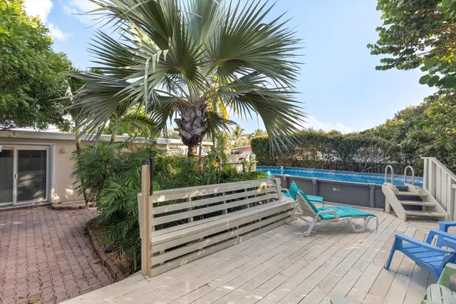 a view of a chairs and table in the back yard of the house