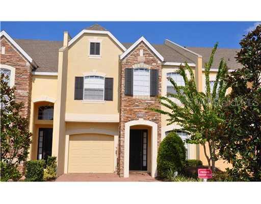 779 Terrace Spring Drive, Unit 779 Orlando, FL 32828 - Photo 1 of 1 a front view of a house with a yard